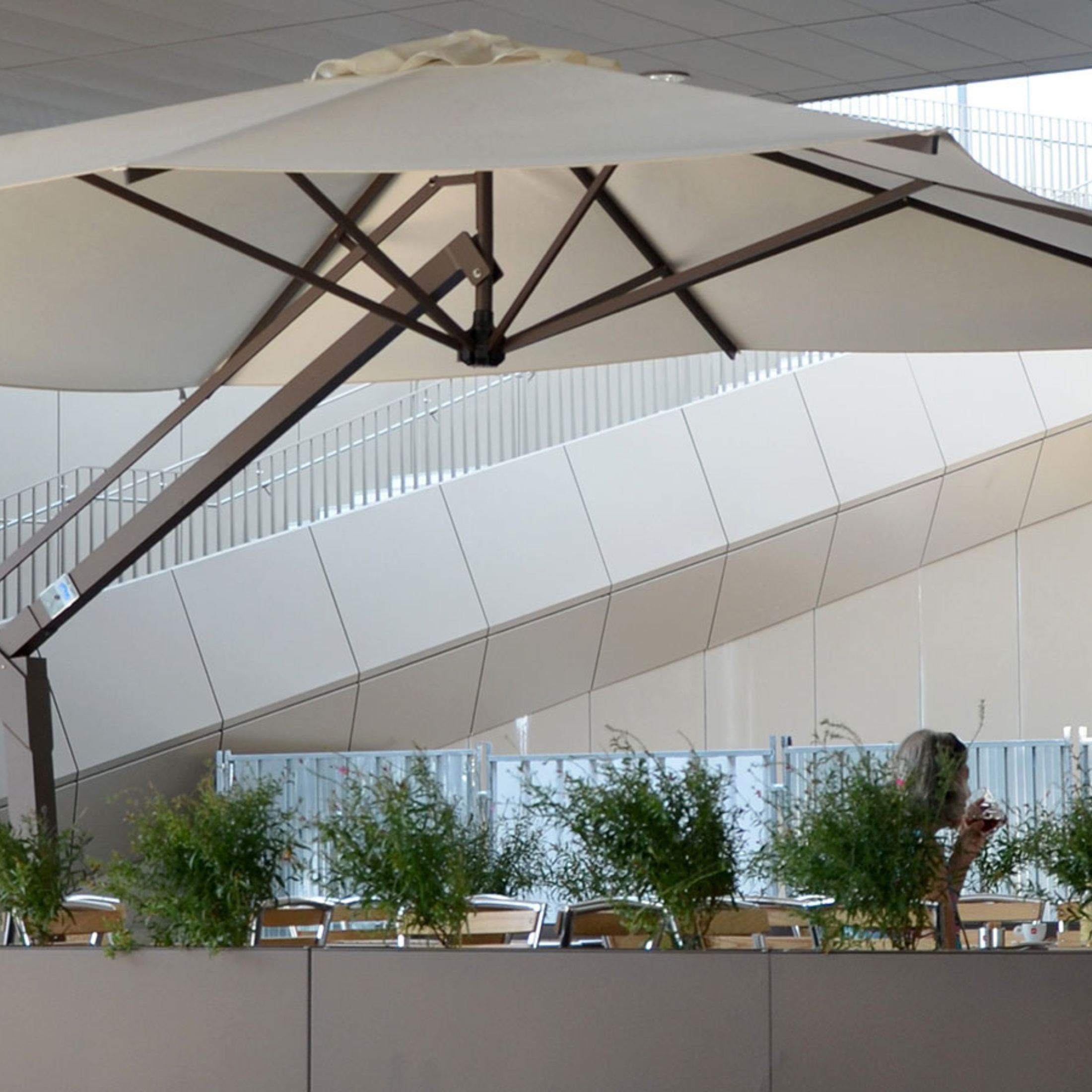 Modern white "Avantage Contract" garden umbrella with retractable side pole