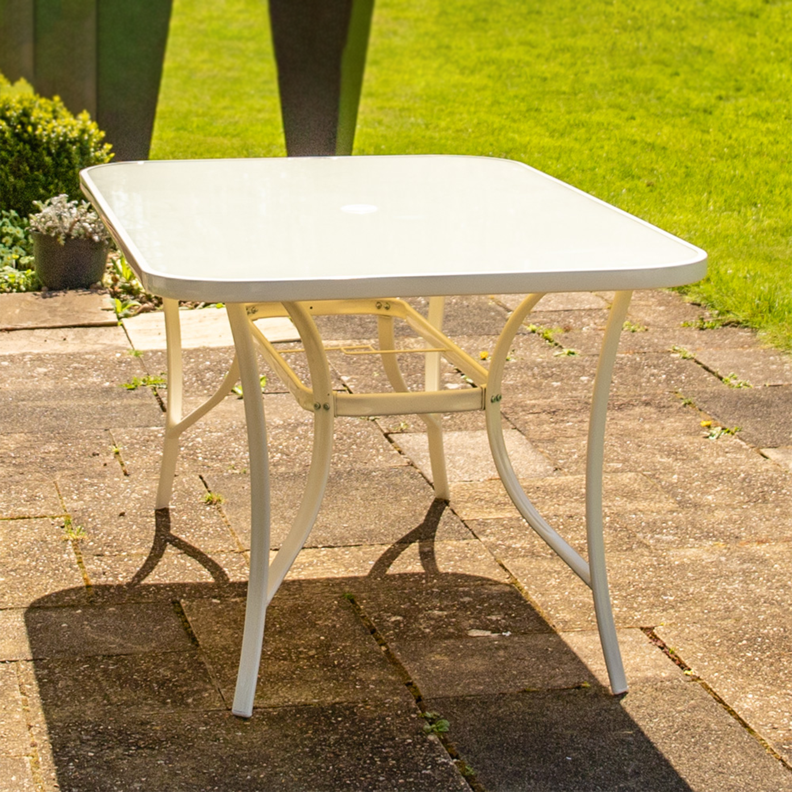 "Giove" metal dining table with tempered glass top and umbrella holder for the garden