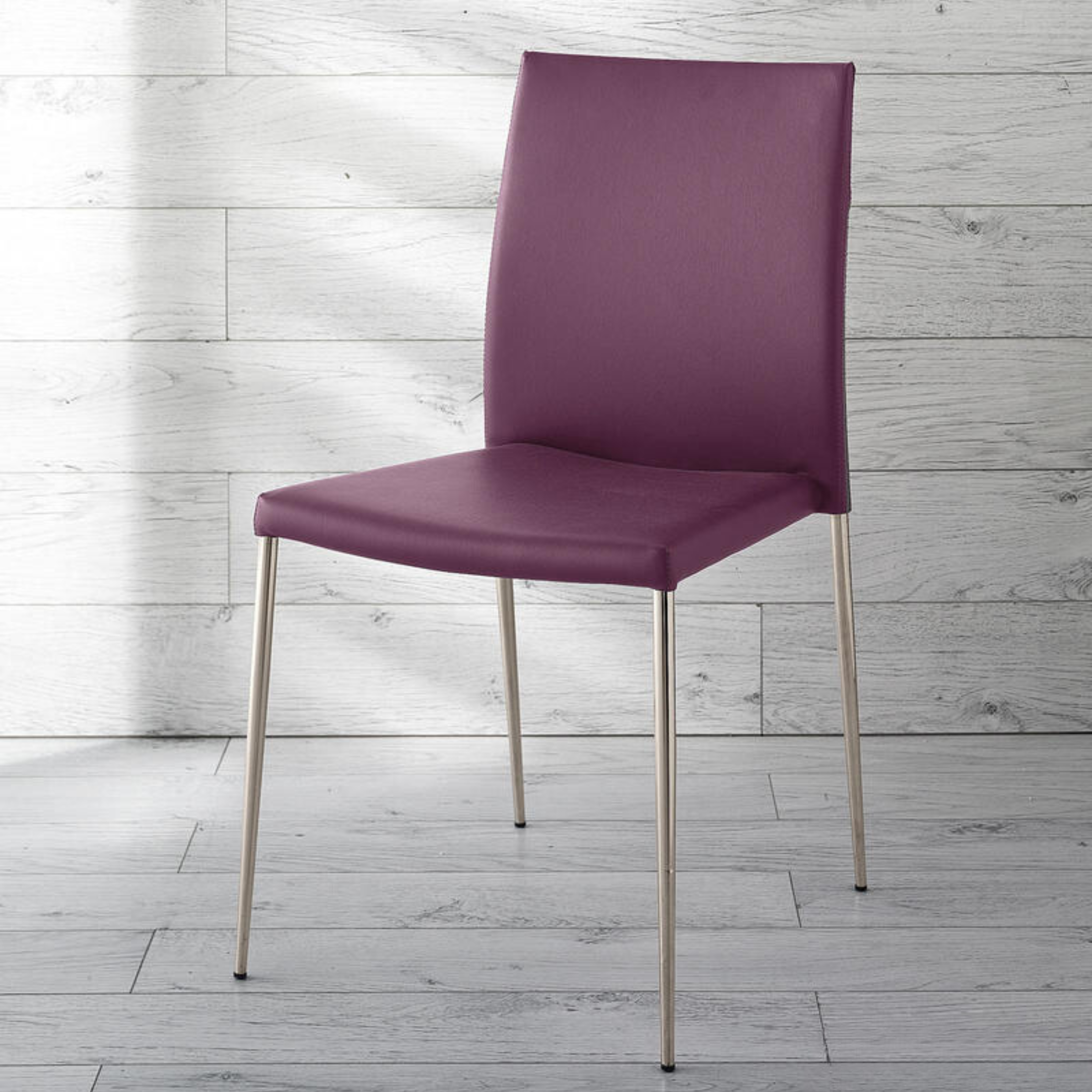 Set of stackable "Camelia" faux leather upholstered dining chairs with painted metal legs