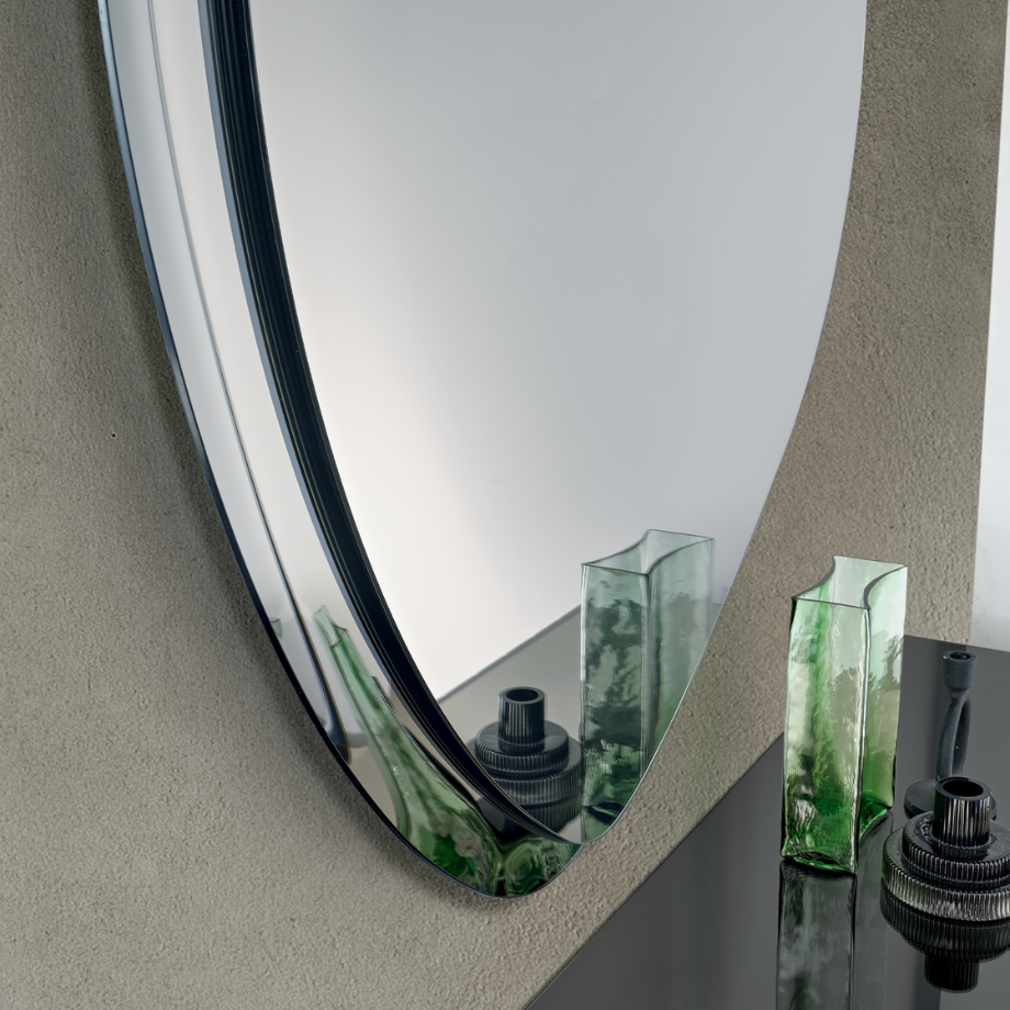 "Silhouette" shaped wall mirror with semi-frame in fused glass