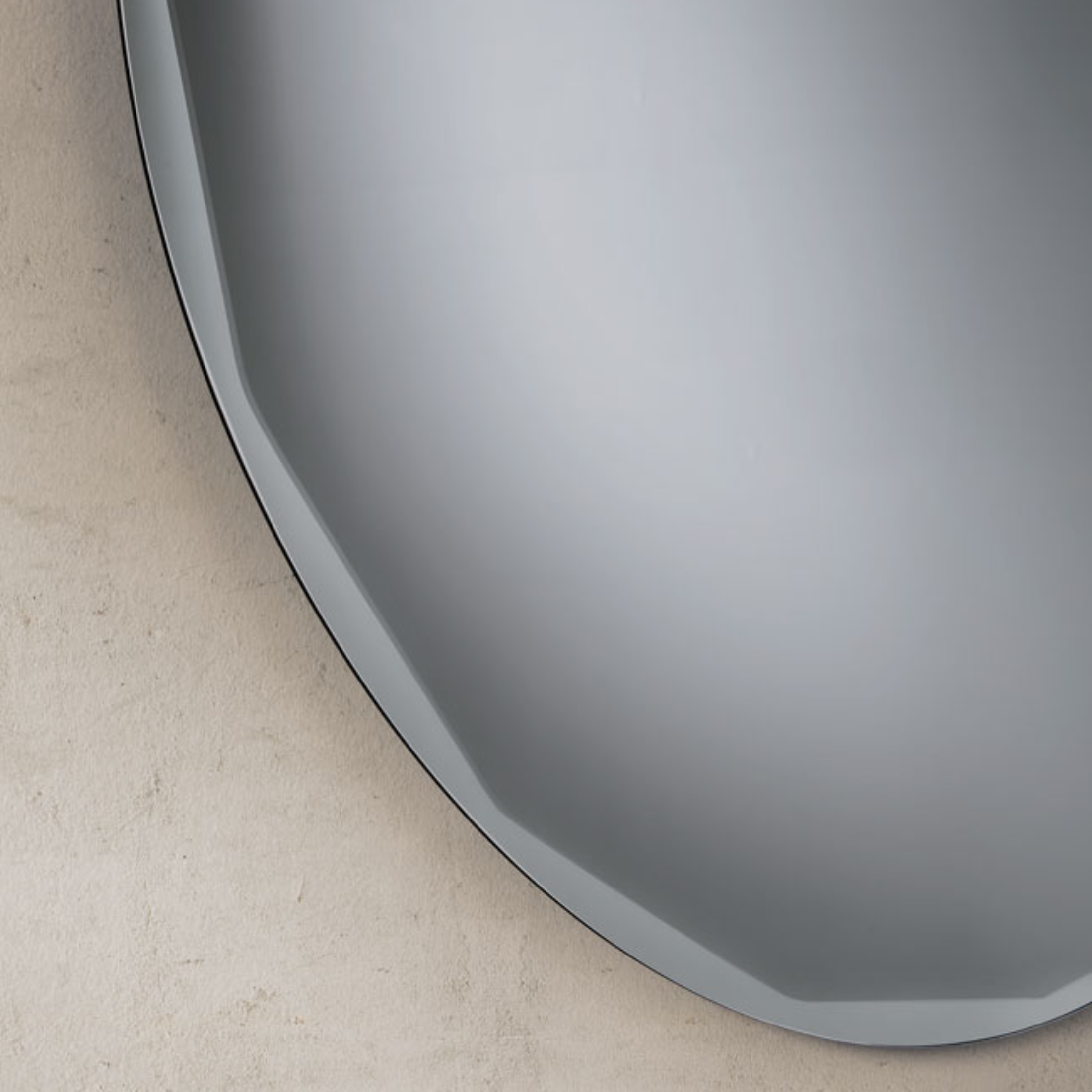 "Pretty" modern round wall mirror with side bevel detail